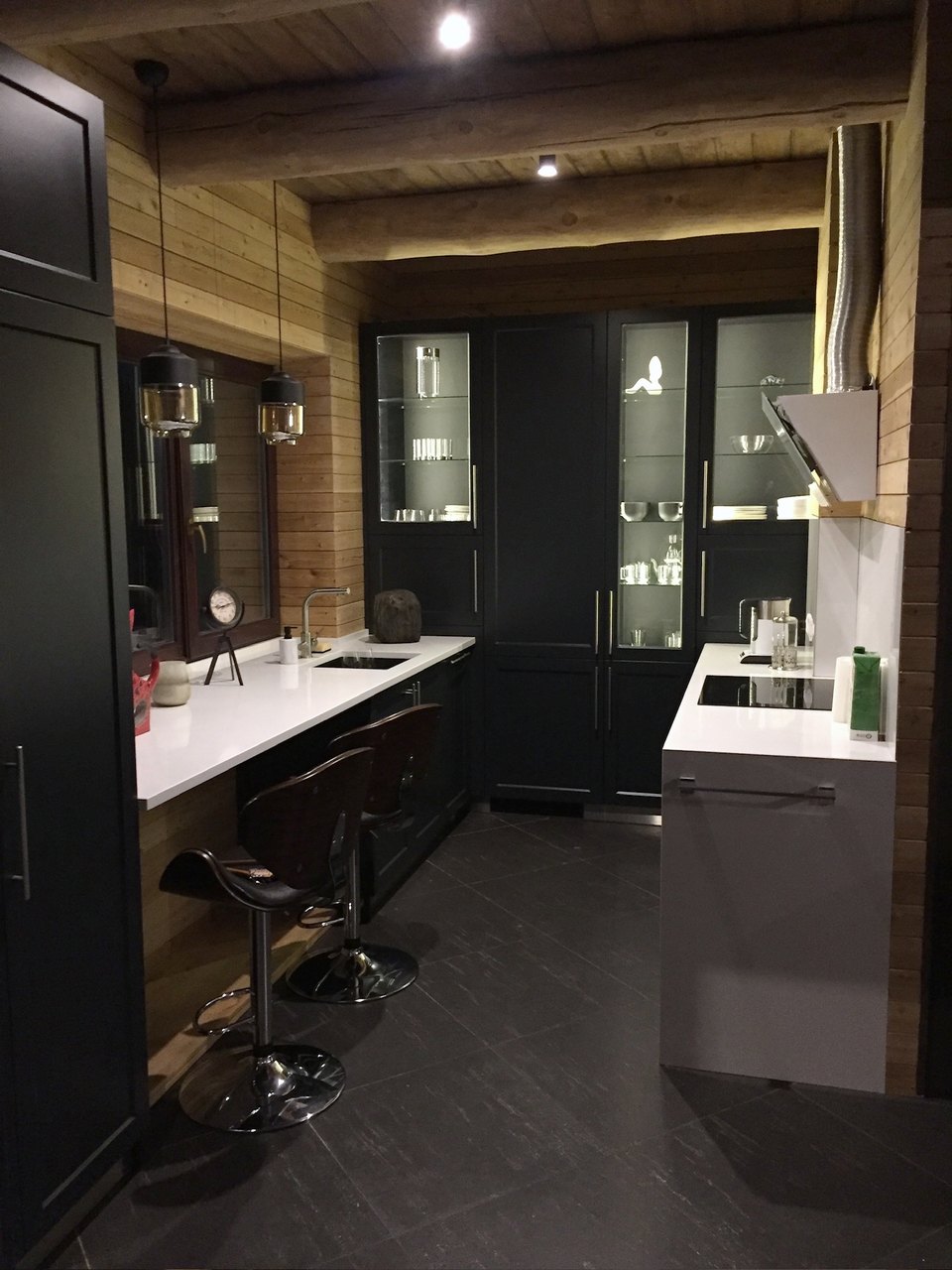 Dark kitchen with glass display cabinets